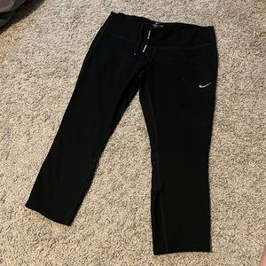 Nike running capris with mesh panels on back of knee and zipper for keys
